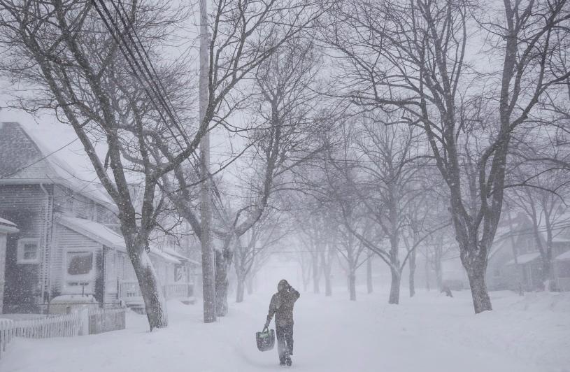 A man walks down the middle of Agricola Street in Halifax as a major winter storm blasts the Maritimes on Monday, Feb. 13, 2017. THE CANADIAN PRESS/Darren Calabrese