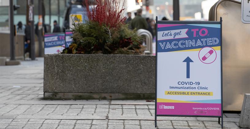TORONTO, ONTARIO, CANADA - MARCH 18, 2021: SIGNAGE DIRECTING PEOPLE TO WHERE TO RECEIVE THEIR COVID-19 VACCINE AT METRO CONVENTION CENTRE.