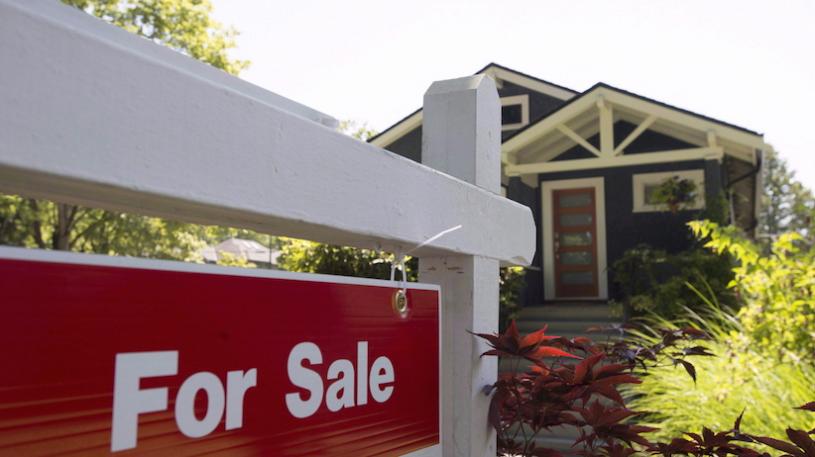 FILE - The Canadian Real Estate Association says July marked the third consecutive month of fewer housing sales. A for sale sign is pictured outside a home in Vancouver in a June, 28, 2016, file photo. THE CANADIAN PRESS/Jonathan Hayward, File