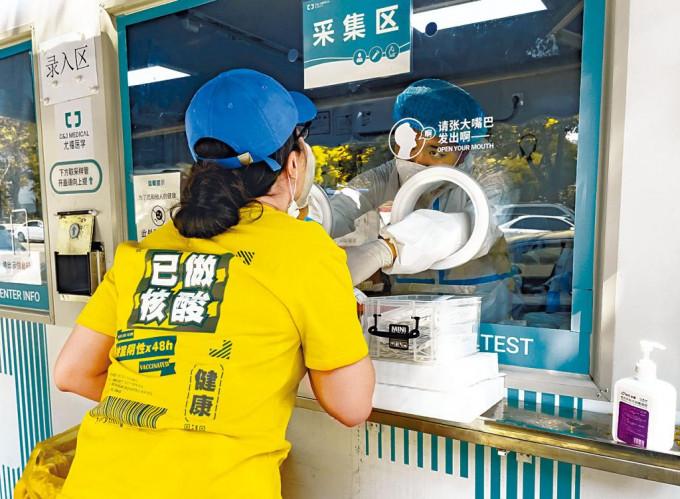 北京市朝陽區市民進行核酸檢測。