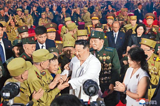 金正恩在韓戰停戰協定簽署六十九周年紀念活動上，與老兵握手。