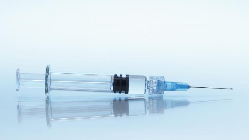Disposable plastic medical syringe with attached hypodermic needle