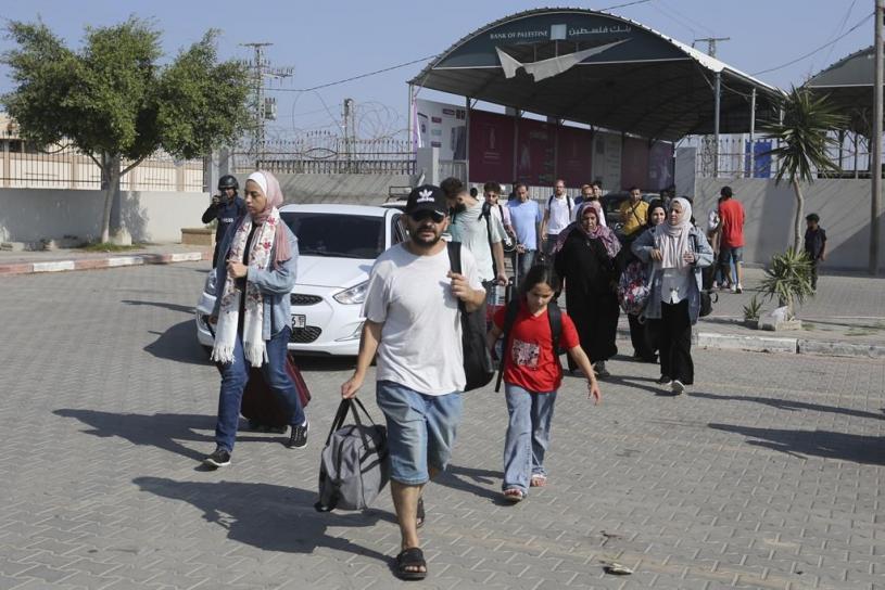 Palestinians cross to the Egyptian side of the border with the Gaza Strip Wednesday, Nov. 1, 2023. in Rafah Wednesday, Nov. 1, 2023. (AP Photo/Hatem Ali)